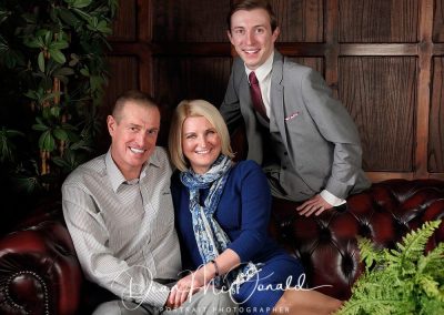 Family portrait in elegant indoor setting.