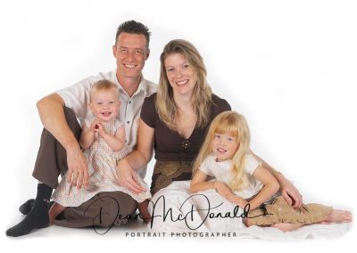 A high Key family portrait colour matched with brown tones.