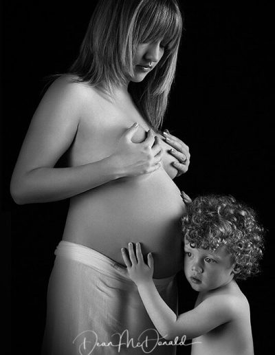 Child Listening Pregnant Mother's Belly - Low-Key background.