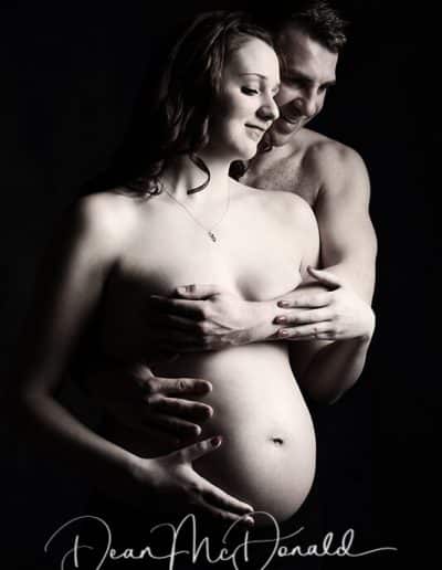 Couple embracing during maternity photoshoot.