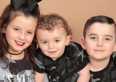 Three children in matching outfits.
