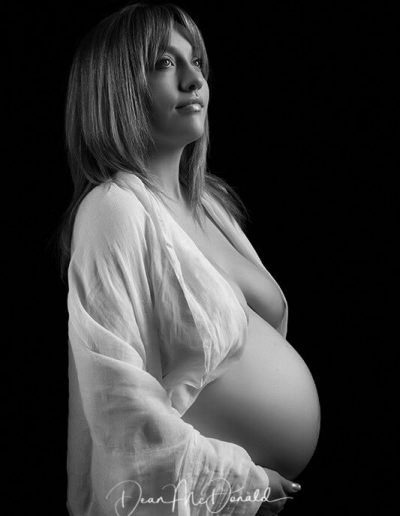 Maternity Portraits of a pregnant woman in artistic pose.