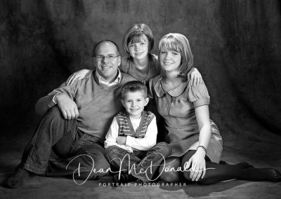 Casual family portrait in matching outfits in black and white