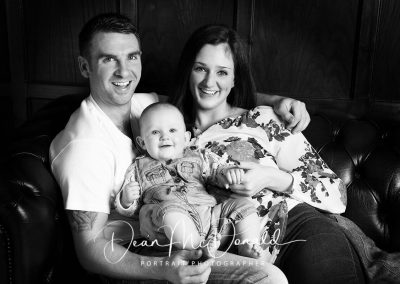 Family Portrait sitting on a sofa in black and white.