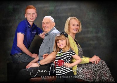 A studio family portrait of grandparents and grandchildren