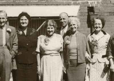 Photographic Restoration of a old sepia photograph. Group photo in vintage attire.