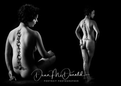 Artistic nude in black and white with intricate back tattoo.
