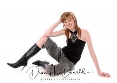 A teenager stylish black outfit modeling in elegant pose.