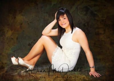 A teenager in a white dress and white stiletto shoes with chrome heels.