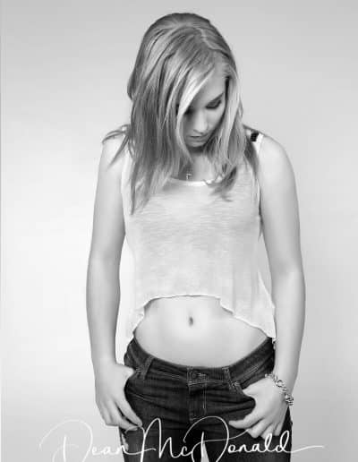 A teenager in a casual pose in monochrome.
