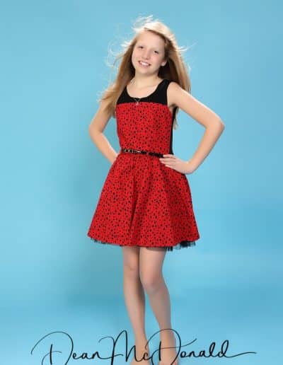 Young teenager in red and black dress.