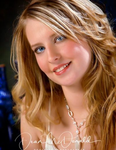 Elegant woman with wavy blonde hair. Headshot Portrait.