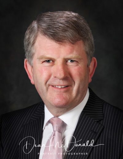 Smartly dressed man in pinstripe suit.