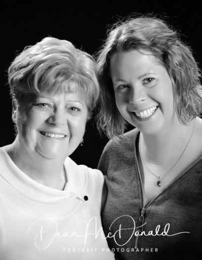 Two women posing closely together.